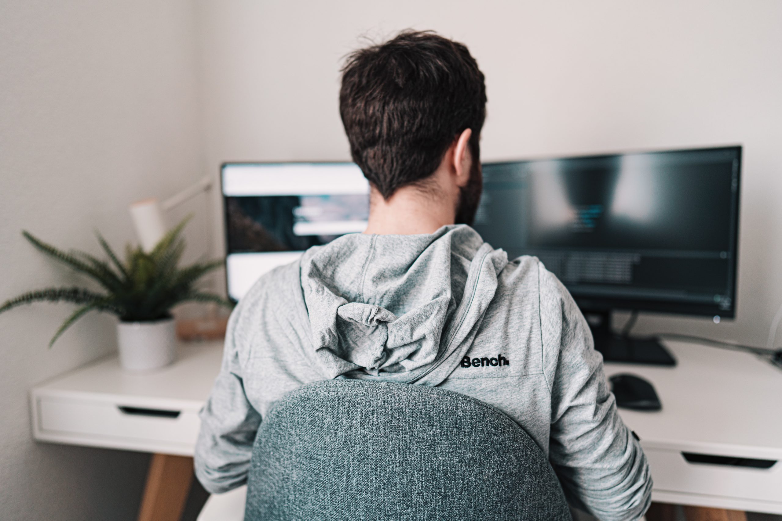 man in gray hoodie sitting on chair