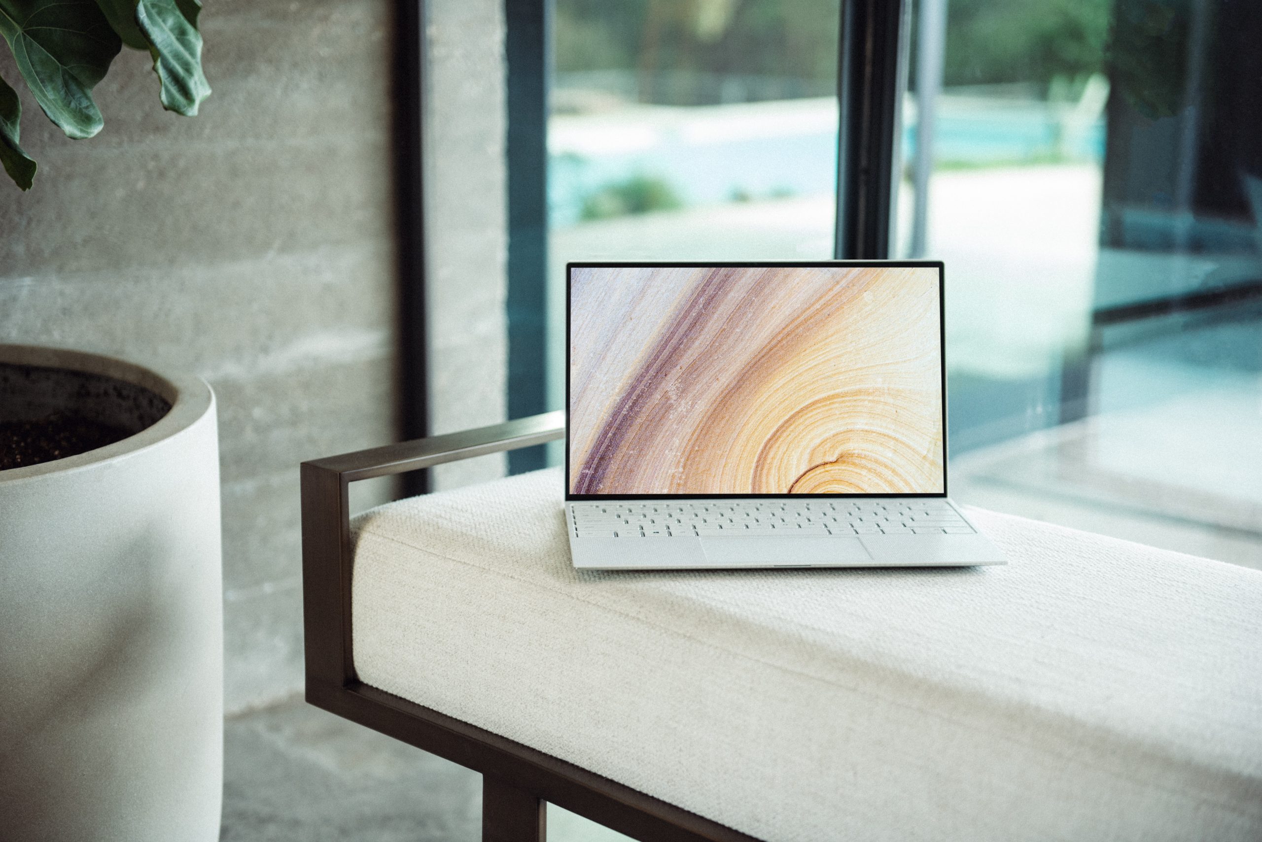 silver macbook on brown wooden table