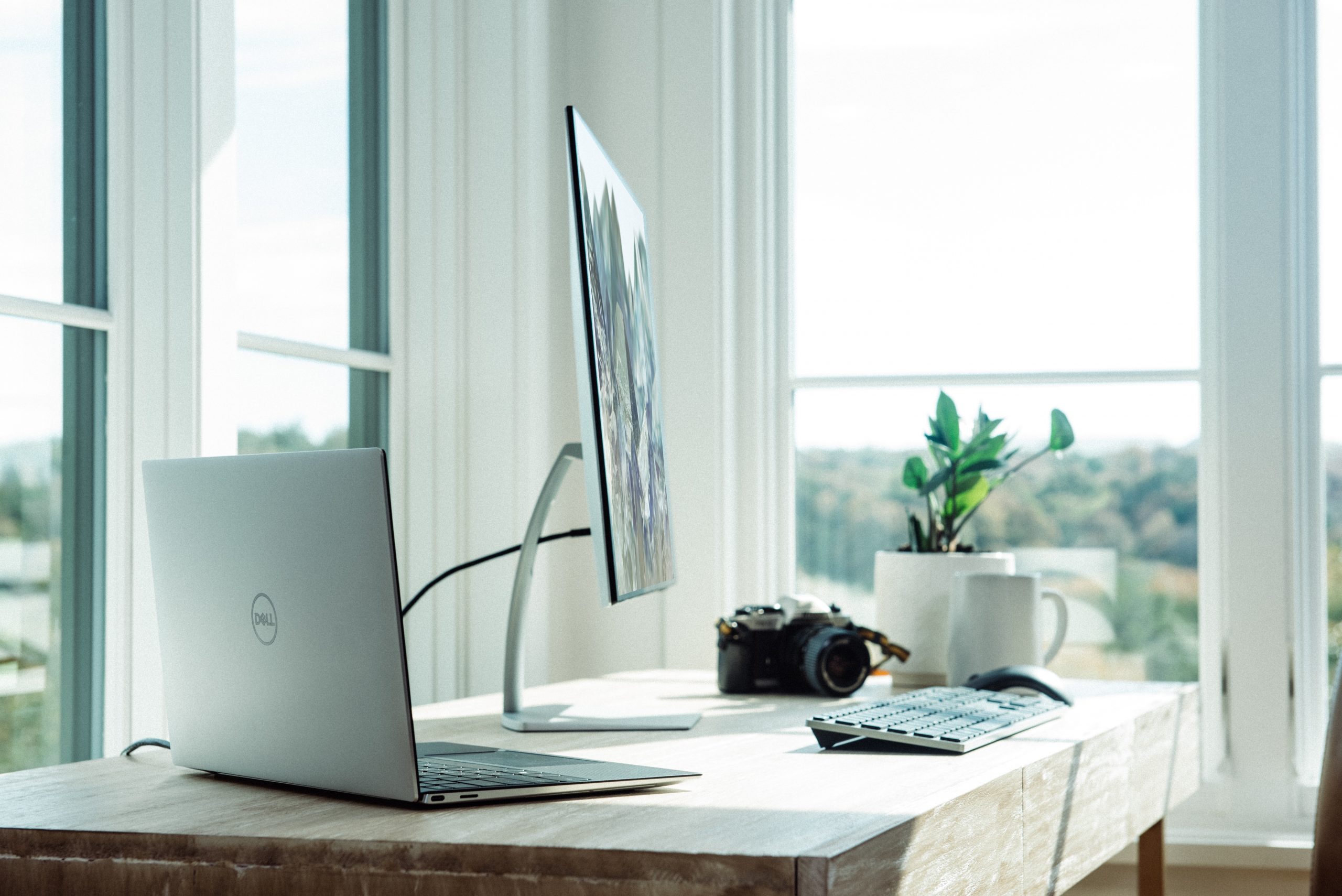 silver macbook on white table