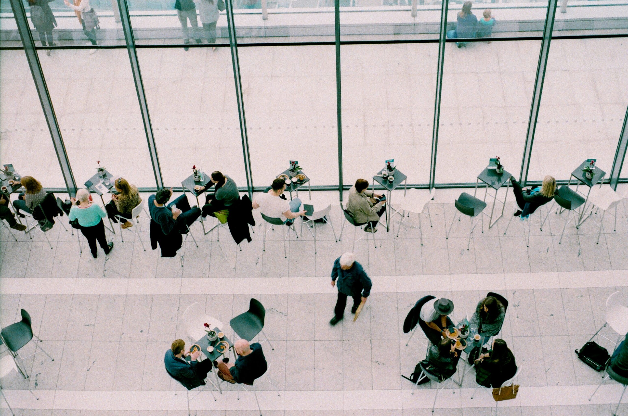 people sitting on chairs near tables during daytime