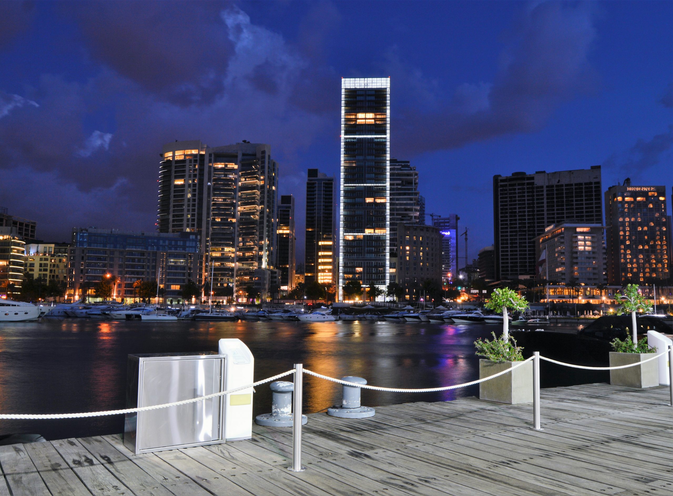 brown wooden dock near body of water at night